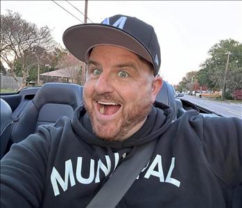 Man with a big smile enjoying a car ride